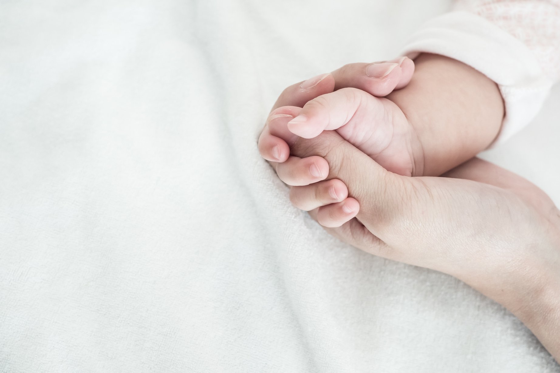 New Born Baby hand hold finger of mom: