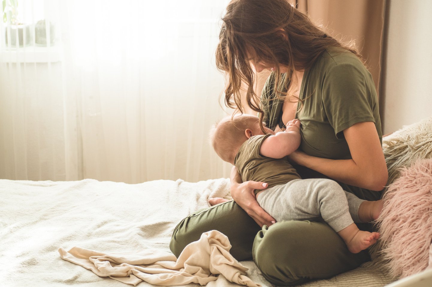 Portrait of mom and breastfeeding baby.